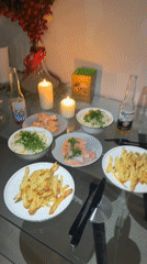 Candlelit seafood dinner documented on glass table in Dubai