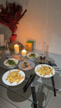 Candlelit seafood dinner documented on glass table in Dubai