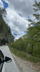 Car navigates narrow mountain road near tunnel in Montenegro