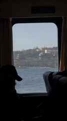 Passenger observes Mediterranean coastline from boat near Milazzo
