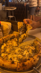 Diner enjoys mushroom pesto pizza at Baan Mae Nam restaurant