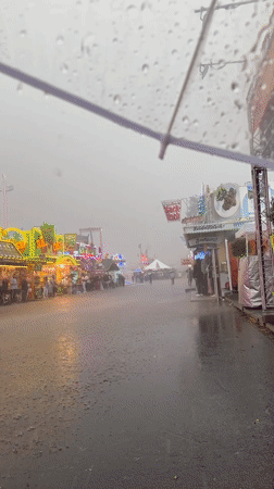 Rainy evening at a Rhine embankment funfair in Düsseldorf