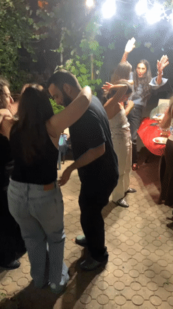 Nighttime backyard party with dancing and snacks
