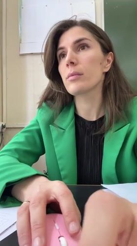 Woman works at desk in Kaspiysk school setting