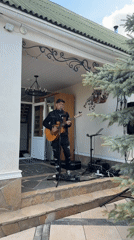 Street musician performs outdoor concert in Russian village