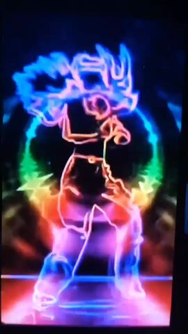 This video is a close-up shot of a person dancing against a dark background. The dancer is illuminated by neon lights that outline their silhouette in various vibrant colors, including pink, purple, blue, green, yellow, and orange. The dancer has long, flowing hair, also outlined in neon lights. They are wearing a dark shirt with "AC" printed on it. The overall effect is dynamic and energetic, with the neon lights pulsing and shifting around the dancer. There are also starburst-like light effects emanating from the dancer's legs and a circular rainbow-like halo behind them. The shot is slightly blurry due to the movement of the dancer and the camera.