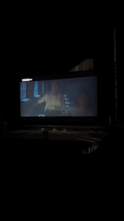 Evening horror film viewing session captured on home television