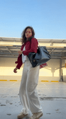 Woman poses in Dubai parking lot during afternoon