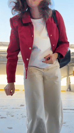 Woman poses in Dubai parking lot during afternoon