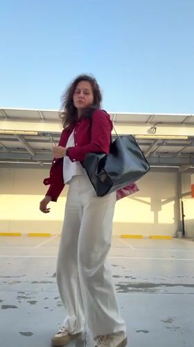 Woman poses in Dubai parking lot during afternoon