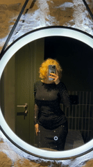 Woman takes selfies in illuminated mirror in Montenegro
