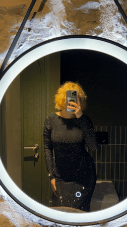 Woman takes selfies in illuminated mirror in Montenegro