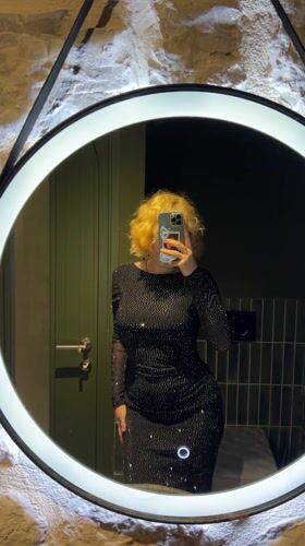 Woman takes selfies in illuminated mirror in Montenegro