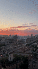 City sunset to evening transition with poolside gathering