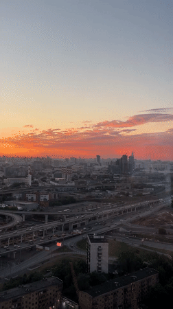 City sunset to evening transition with poolside gathering
