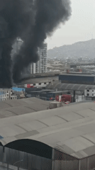 Large building fire blankets Breña in thick black smoke