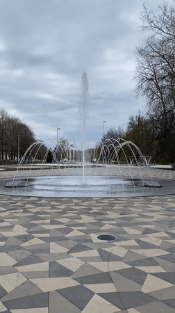 Person runs through fountain in Kingisepp park