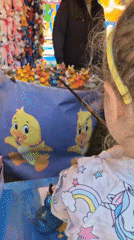 Child plays duck game at Sofia carnival