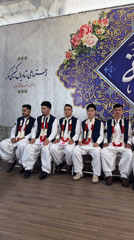 Formal ceremony with garlanded men in traditional dress, Quetta