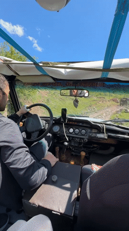 Driver navigates dirt road in convertible near Teghut, Armenia