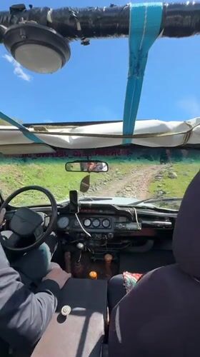 Driver navigates dirt road in convertible near Teghut, Armenia