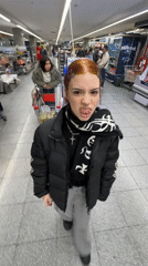 Woman makes playful gesture in Buenos Aires grocery store