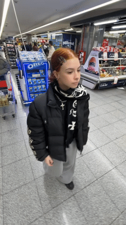 Woman makes playful gesture in Buenos Aires grocery store