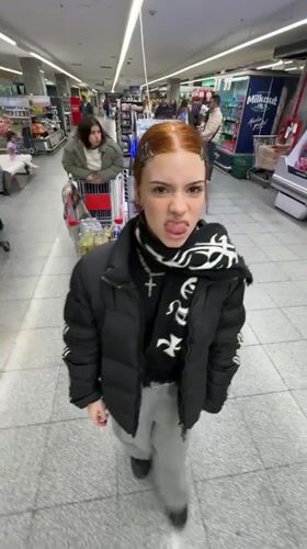 Woman makes playful gesture in Buenos Aires grocery store
