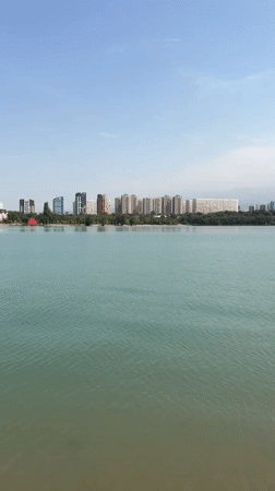 Casual morning at an Almaty lakeside with bikes, benches, and city views