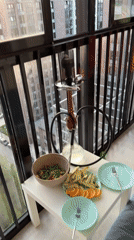 Moscow balcony meal setup captured with fruit, salad, hookah