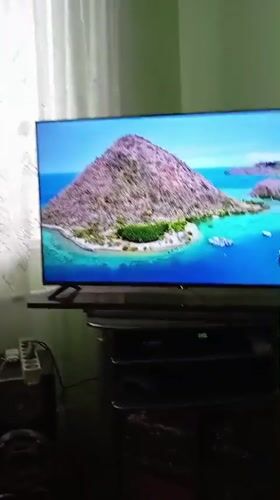 TV displays tropical beach footage in Uzbekistan living room