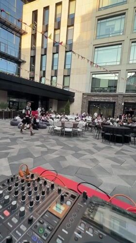 Casual outdoor DJ event observed in Kazan amid modern architecture