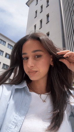 Woman records outdoor selfie videos in sunlit Milan