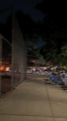 Nighttime crowds gather on busy New York street