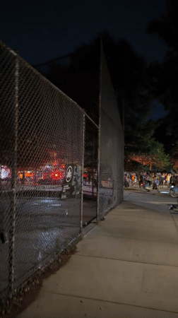 Nighttime crowds gather on busy New York street