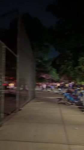 Nighttime crowds gather on busy New York street
