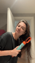 Woman dries hair in Belgrade bathroom Monday morning
