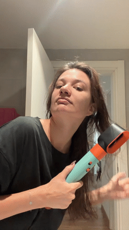 Woman dries hair in Belgrade bathroom Monday morning