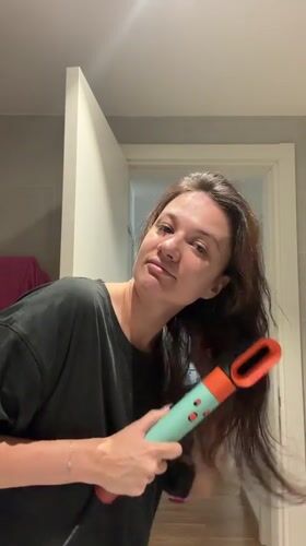 Woman dries hair in Belgrade bathroom Monday morning