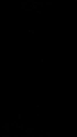 The video captures a brief glimpse of what appears to be a street scene. A dark object, possibly a car, is visible at the bottom of the frame. The rest of the image is obscured by darkness, making it impossible to discern further details about the environment or any potential actions.