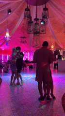 Couples slow dance at colorful Pattaya venue