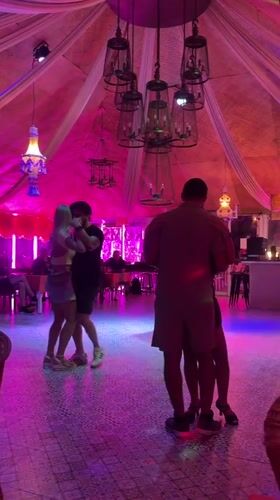 Couples slow dance at colorful Pattaya venue