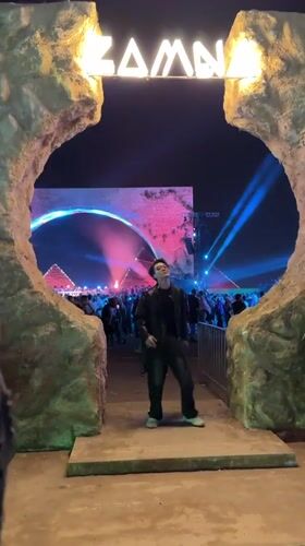 Man enters ZAMNA event through lit archway in Giza