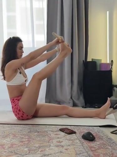 Woman practices morning yoga at home in Tyumen