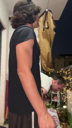 Young man barbecues on balcony in Kiryat Bialik