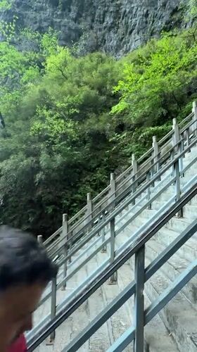 Tourists climb stone stairs to rock formations in Zhangjiajie