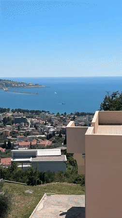 White yacht cruises past Šušanj Montenegro coast