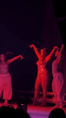 Singer performs with dancers at Milan concert venue