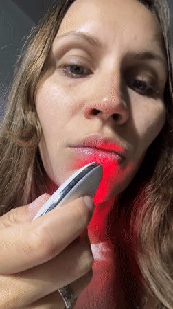 Woman uses LED beauty device during skincare routine in Fethiye