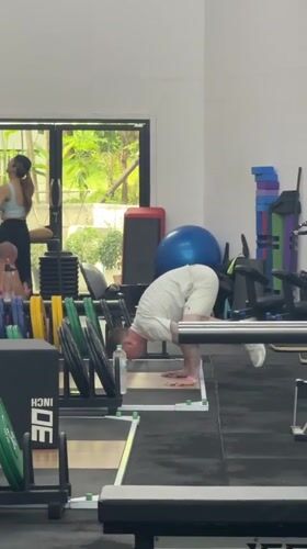 Man performs handstand exercise at Thailand gym